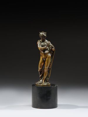 une statue en bronze représentant une femme tenant un enfant dans ses bras, posée sur un socle
