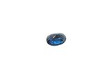 a close up of a blue sapphire stone on a white surface