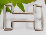 a close up of a metal object with leaves in the background
