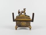 an antique brass box with two dogs on top of it