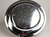 a silver plate with a circular design on it