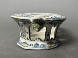 a small blue and white vase with a bird on it