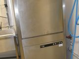 a stainless steel refrigerator in a kitchen with a blue hose