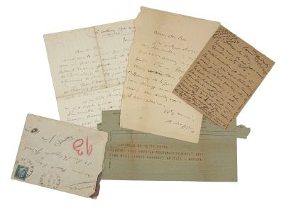 several old letters are stacked on top of each other on a table