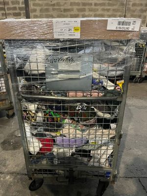 a metal cart with many items in it in a warehouse