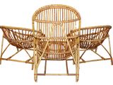 a wicker chair and two chairs sitting next to each other
