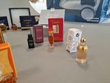 bottles of perfume and boxes on a table in a room
