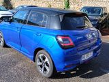 a blue car that is parked in a parking lot