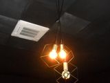 a black ceiling with two light bulbs hanging from the ceiling