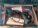 a box with a drill and other tools inside of it