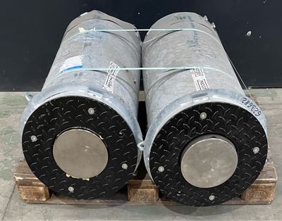 two metal pipes sitting on a pallet on a pallet