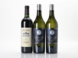 three bottles of wine sitting next to each other on a table