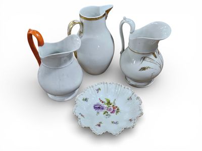 four pieces of white porcelain with flowers on them