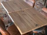a wooden table and chairs in the middle of a room