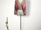 an image of a mannequin with a pink blouse and black hat