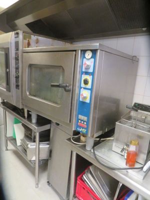 a picture of a commercial kitchen with stainless steel appliances