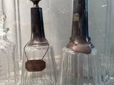 three glass bottles that are on display in a glass case