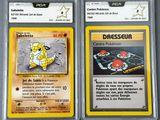 two pokemon cards with different designs on them sitting on a table