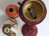three vases and a bowl on a table