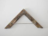 a close up of a triangle shaped object on a white surface