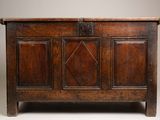 an old wooden chest sitting on top of a white floor