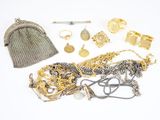 a lot of gold and silver jewelry on a white surface