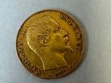 a close up of a gold coin with a man ' s face on it