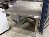 a metal table that is sitting in the middle of a room