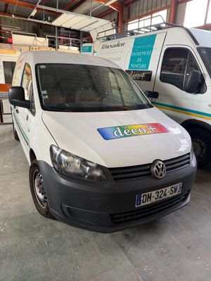 a white van parked next to a white van in a garage