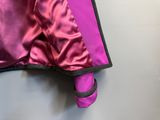 purple satin jacket with black trim and cuffs hanging on a hanger