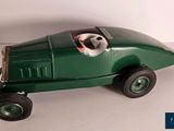 a green toy car with a dog in it