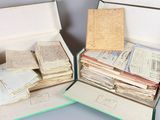 two open suitcases filled with old books on a table