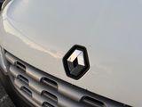 a close up of a white car with a black emblem on it