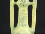 un vase vert posé sur un fond noir