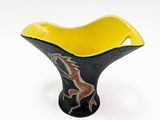 black and yellow ceramic bowl with a horse design on it