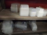 many containers of milk on a shelf in a room