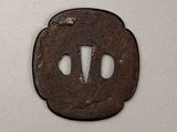a close up of a small metal object on a white surface