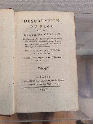 an open book on display in a glass case