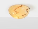 a close up of a piece of yellow marble on a white surface