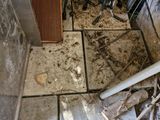 a lot of debris on the floor in the kitchen