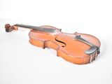 an old violin sitting on top of a white surface next to a white wall