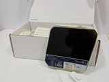 a box with a keyboard and a cell phone inside of it