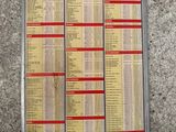two large red and yellow timetables sitting on a table
