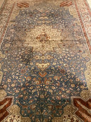 an image of a large oriental rug on a wooden floor
