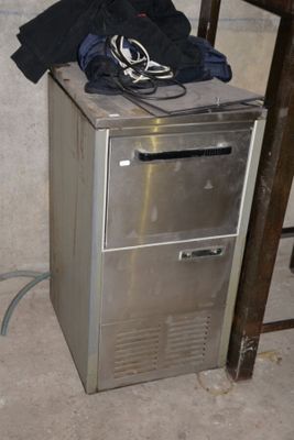 a silver refrigerator sitting in the corner of a room