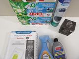 a box of toothpaste, toothpaste paste, toothbrushes, and other cleaning products on a table