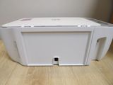 a white printer sitting on top of a wooden table