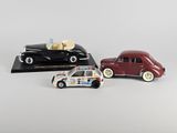 two toy cars are sitting next to each other on a white surface