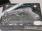 a box with a gun inside of it on a table
