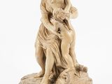 a statue of a woman holding a child on top of a wooden base